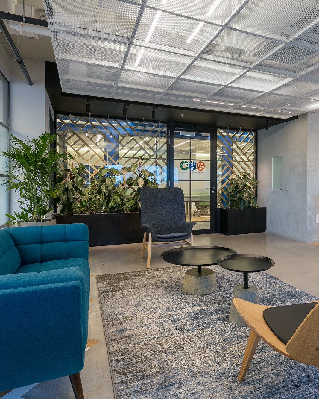 Lounge seating area with armchairs at the Jabil Optics facility