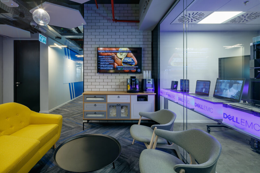 Breakout room with coloured lighting and lounge seating in a Domark office project
