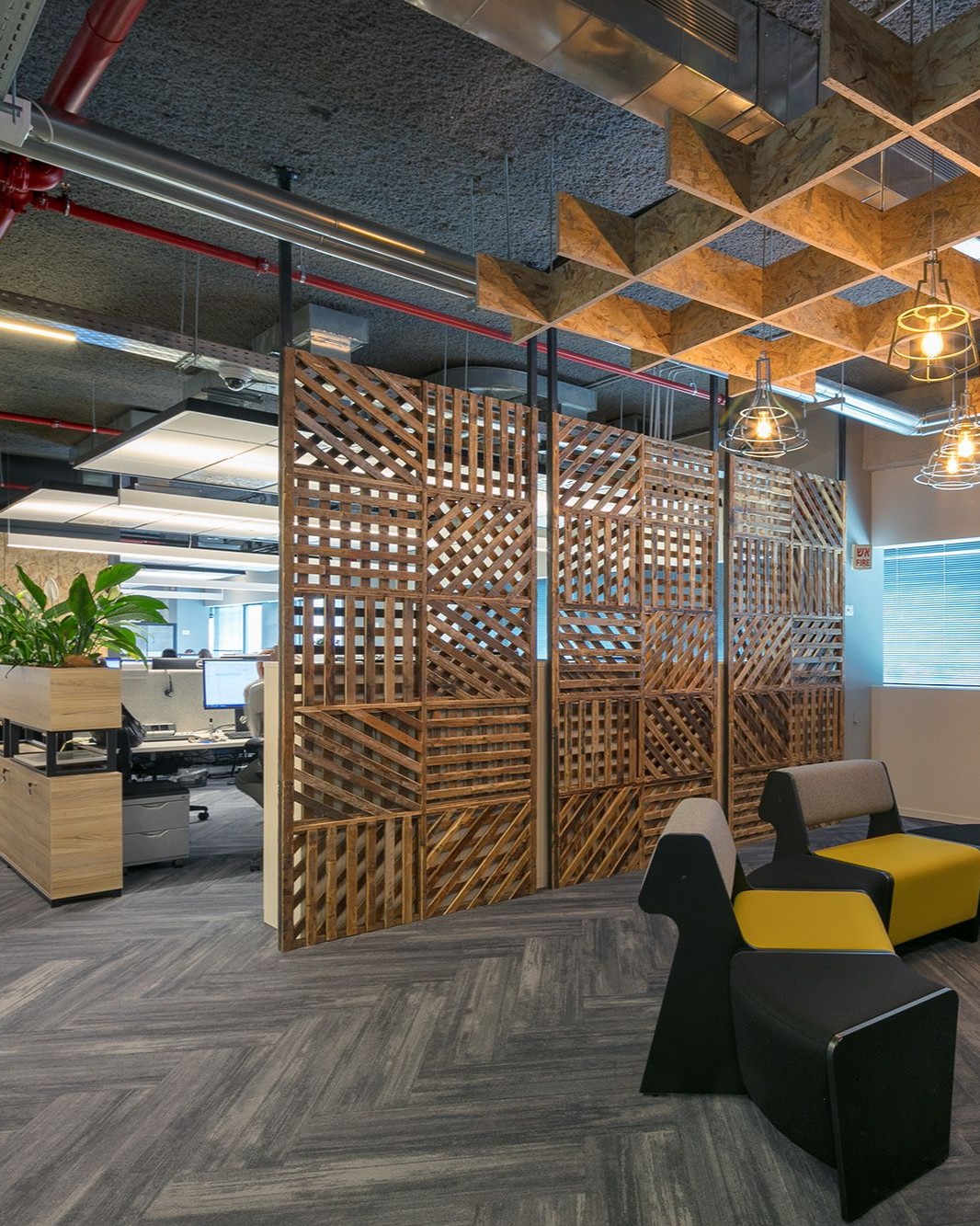 Lounge seating beside a decorative timber screen in a Domark office project