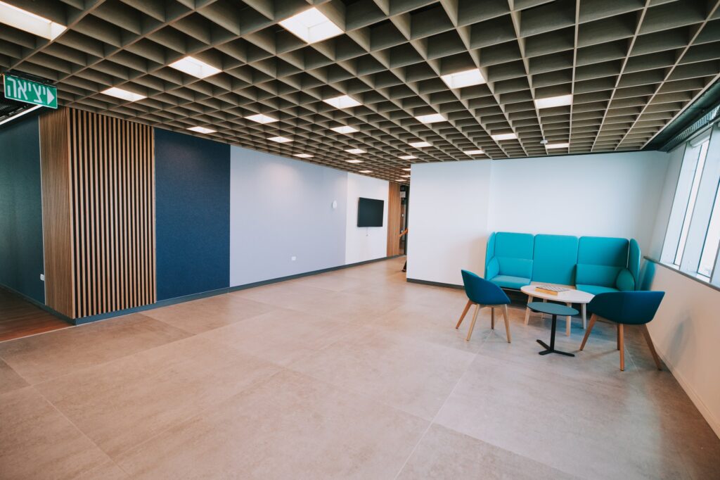 Meeting area with turquoise armchairs and glass partitions at the IBM offices