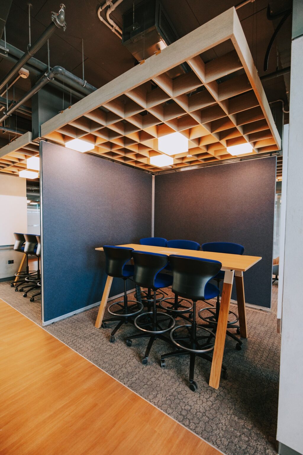 Meeting space with a dark timber ceiling at the IBM offices