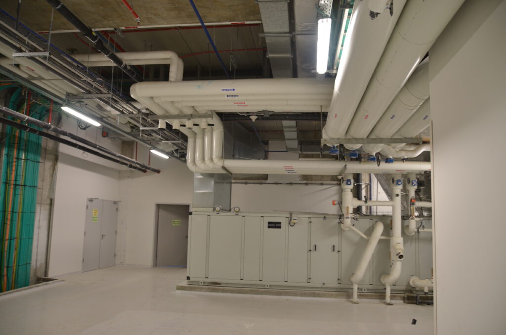 Mechanical services corridor with exposed ductwork at the Rafa facility
