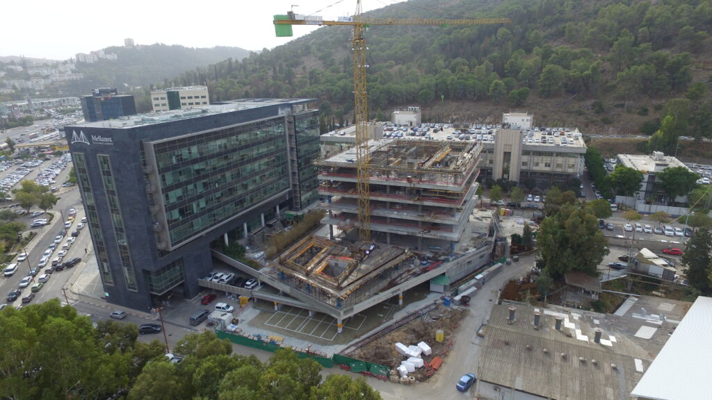 Aerial view of the Mellanox complex under construction with a tower crane