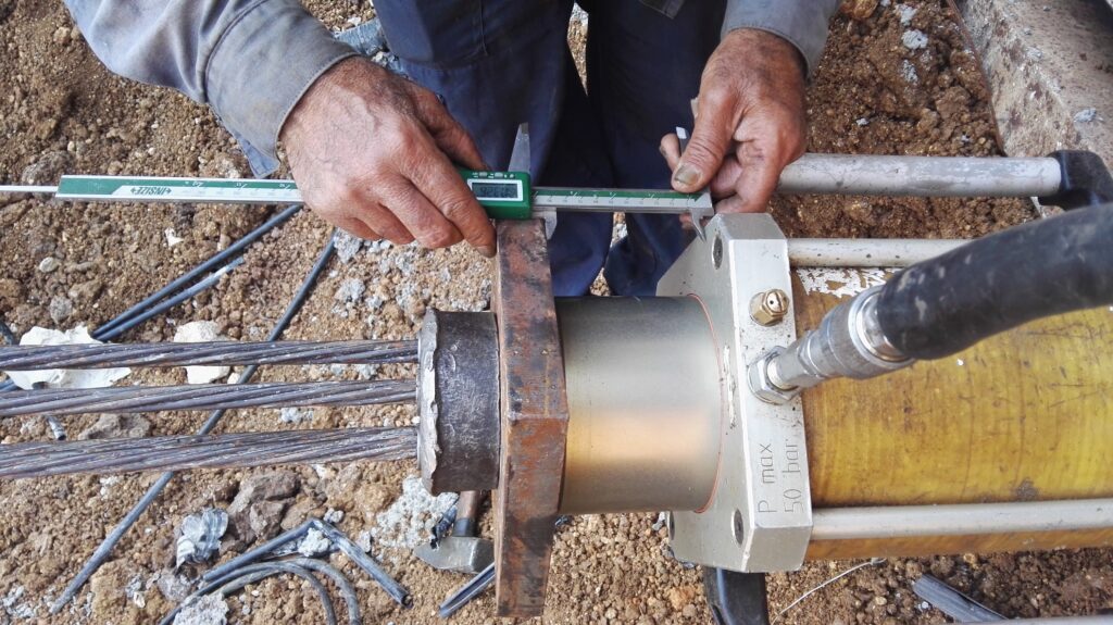 An engineer checking a measurement with a digital caliper on the Mellanox construction site