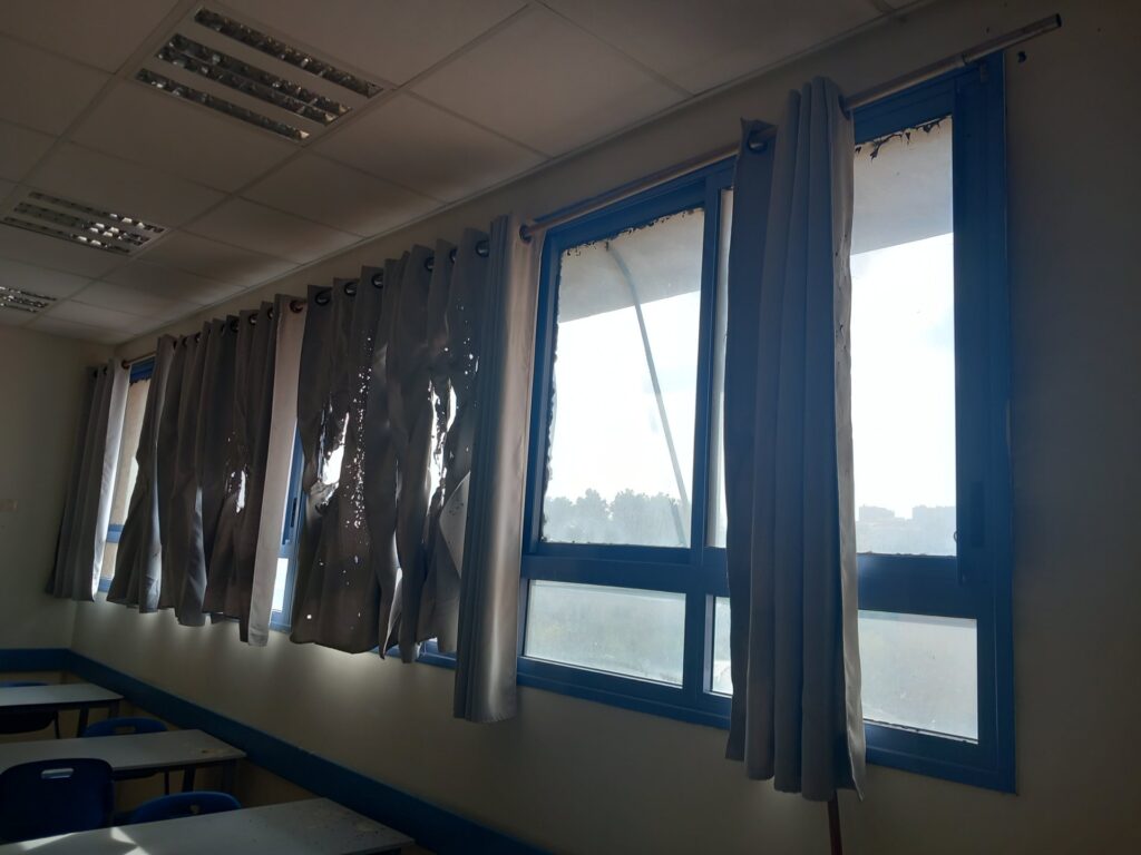A damaged classroom with burnt curtains