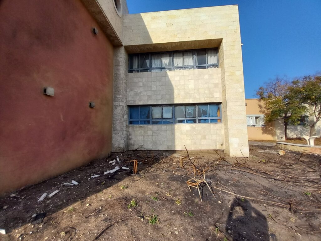 Scorched windows and burnt furniture outside a damaged building