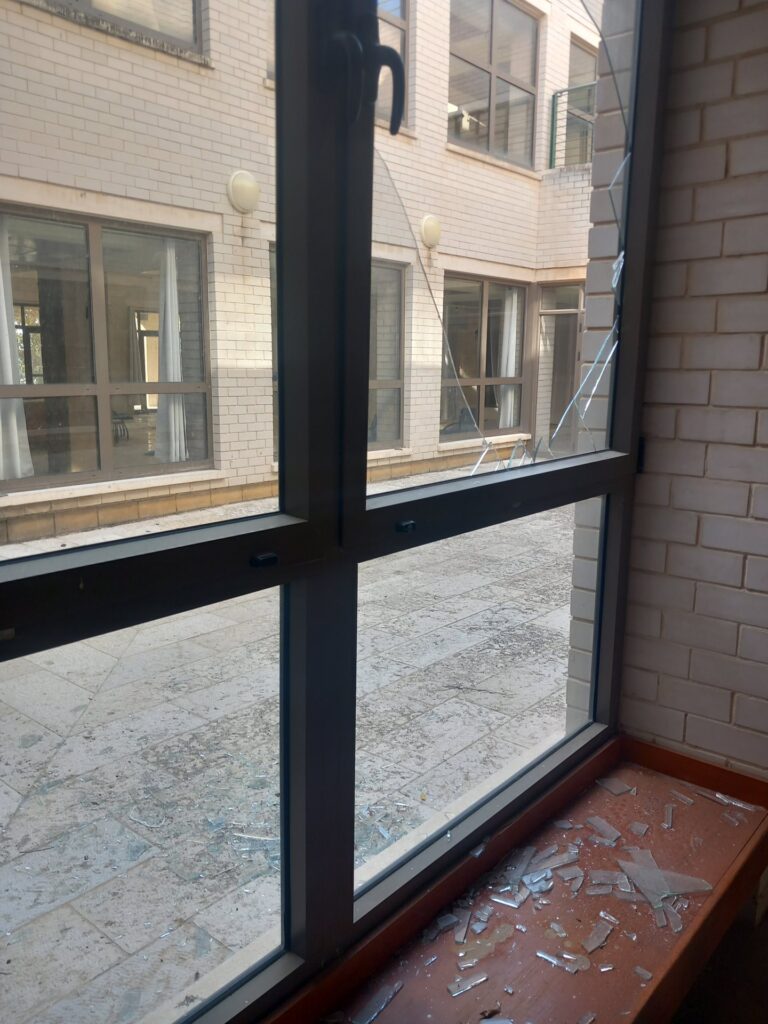 Shattered window glazing in a damaged building