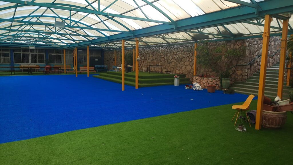 A covered yard with new synthetic turf